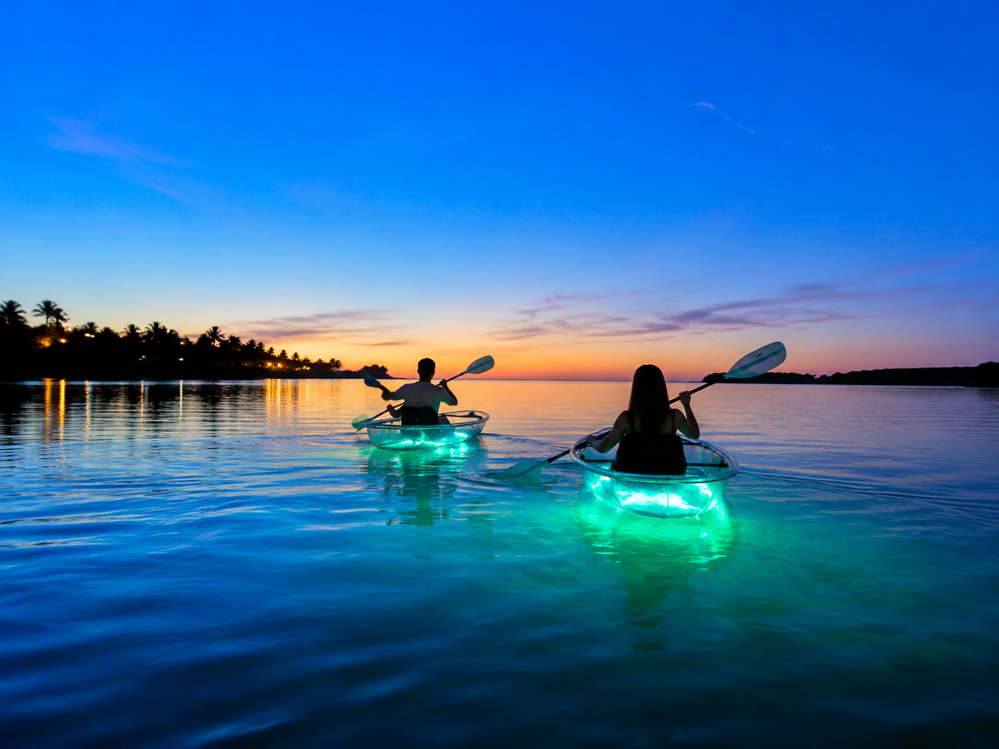 Illuminated clear kayaks at sunset